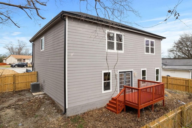 back of house featuring cooling unit and a wooden deck