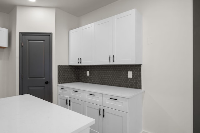 kitchen with white cabinets and decorative backsplash