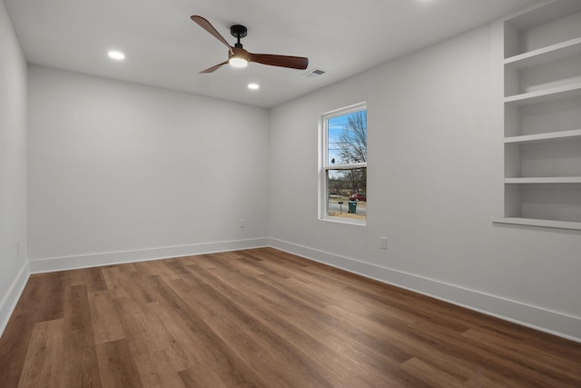 unfurnished room with ceiling fan and hardwood / wood-style flooring