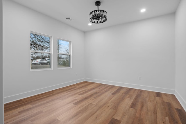 spare room with hardwood / wood-style flooring