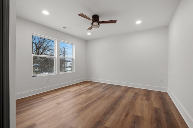 spare room featuring hardwood / wood-style floors and ceiling fan