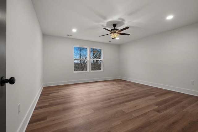 empty room with dark hardwood / wood-style floors and ceiling fan