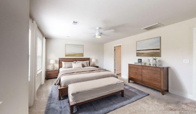 bedroom with ceiling fan and light carpet