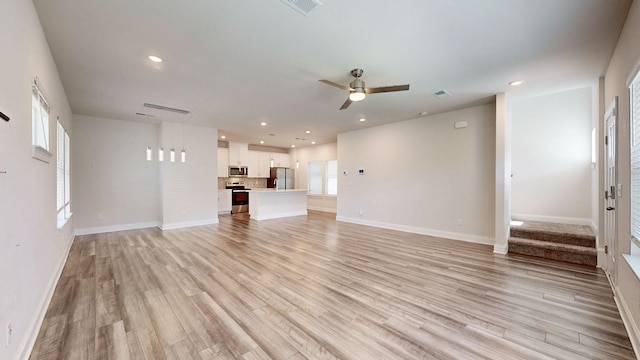 unfurnished living room with ceiling fan and light hardwood / wood-style floors