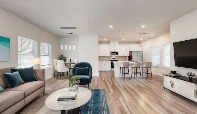 living room with light hardwood / wood-style flooring