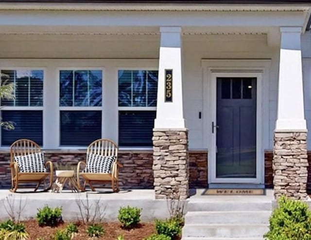 view of exterior entry with a porch