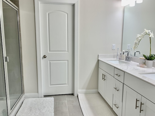 bathroom with vanity, tile patterned floors, and a shower with shower door