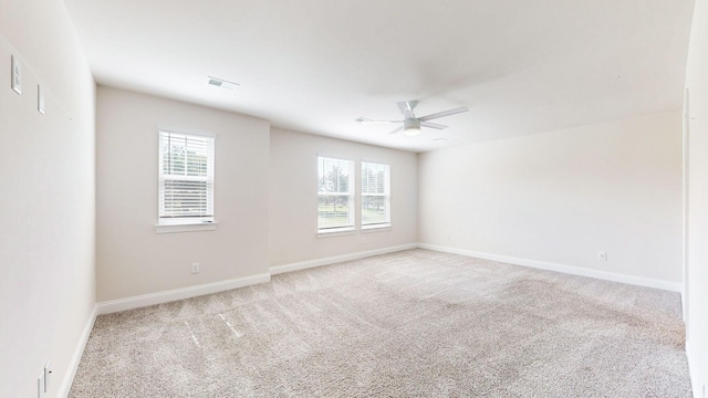 unfurnished room featuring ceiling fan and light carpet