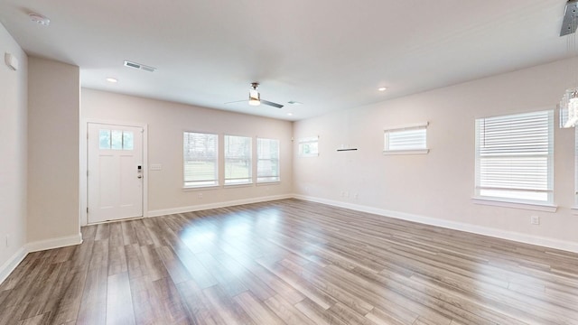 unfurnished living room with ceiling fan and light hardwood / wood-style flooring