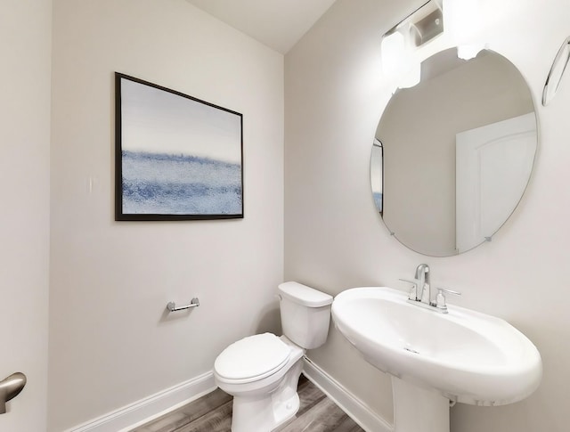 bathroom with sink, wood-type flooring, and toilet