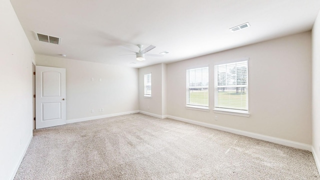 carpeted spare room with ceiling fan