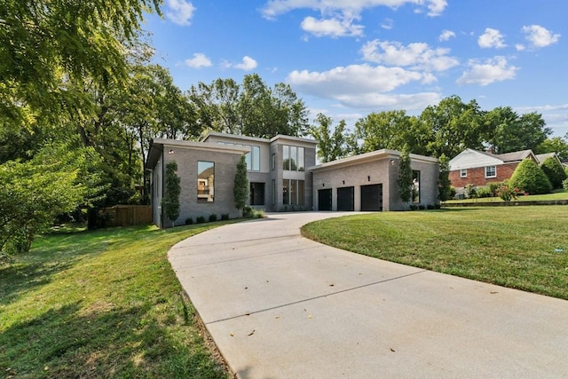 contemporary house featuring a front yard and a garage