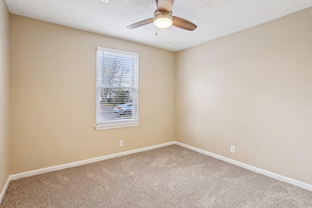 spare room featuring ceiling fan, carpet floors, and a textured ceiling