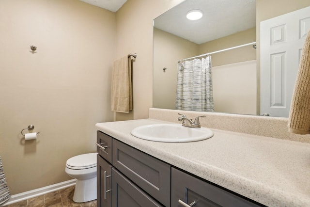 bathroom featuring vanity, toilet, and walk in shower