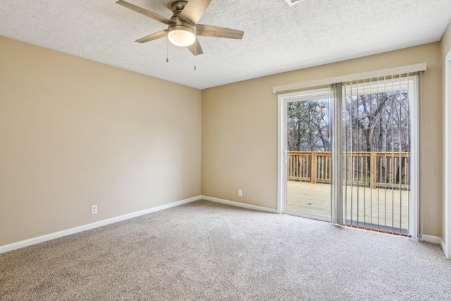 empty room featuring ceiling fan, carpet floors, and a textured ceiling