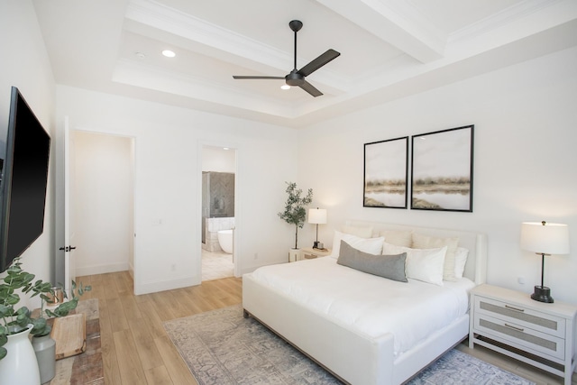 bedroom featuring crown molding, light hardwood / wood-style flooring, ensuite bath, ceiling fan, and beam ceiling