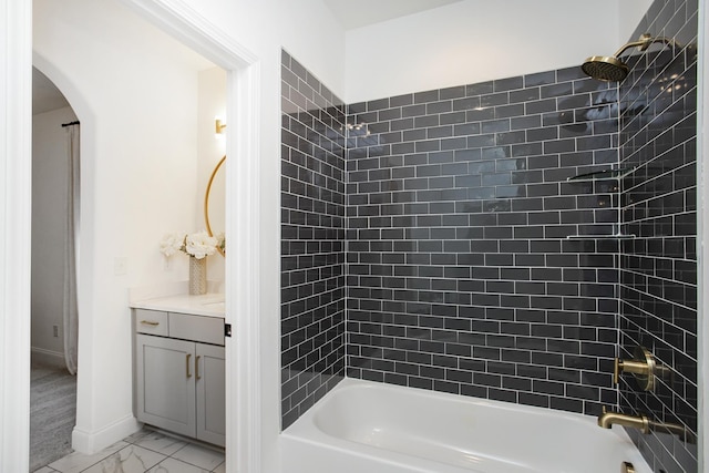 bathroom with vanity and tiled shower / bath combo