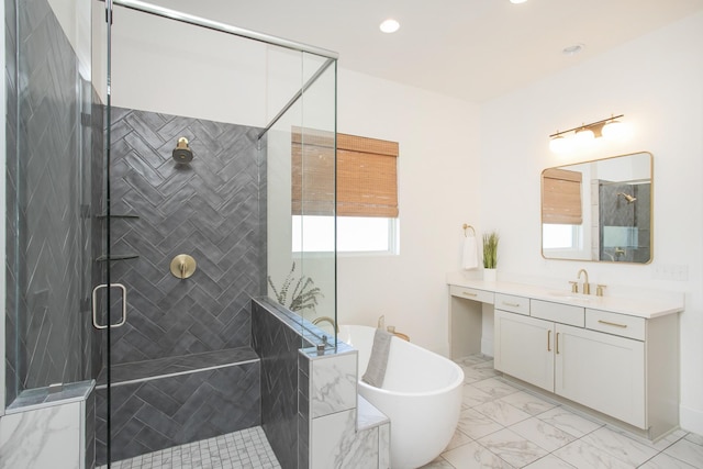 bathroom featuring vanity and shower with separate bathtub