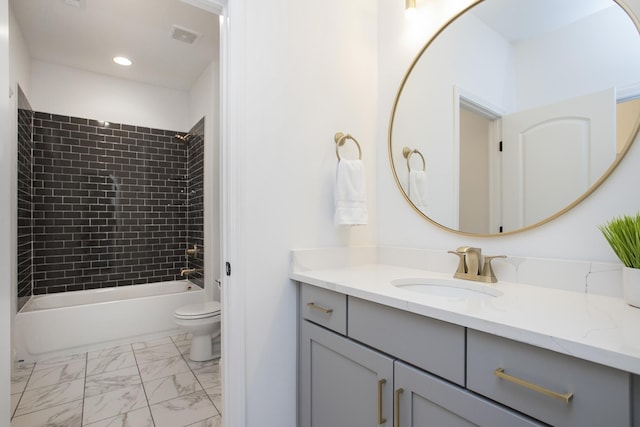 full bathroom with vanity, toilet, and tiled shower / bath