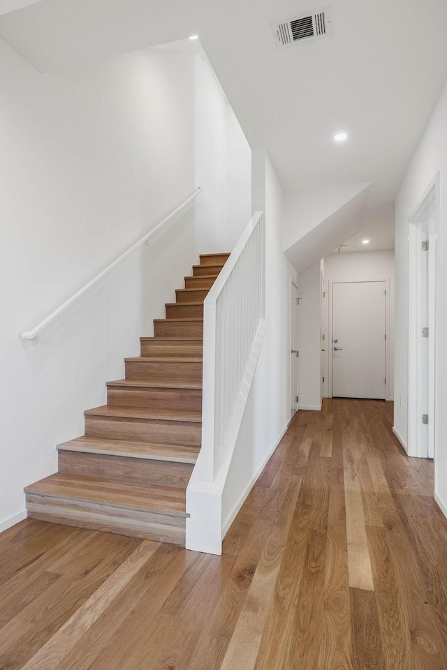 stairs with wood-type flooring