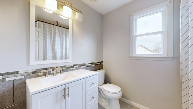 bathroom featuring curtained shower, backsplash, toilet, vanity, and tile walls