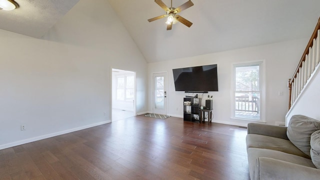 unfurnished living room with dark hardwood / wood-style floors, high vaulted ceiling, and ceiling fan