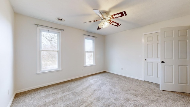 carpeted empty room featuring ceiling fan