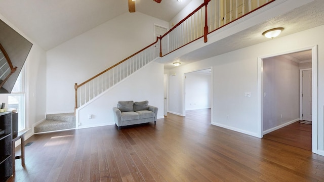 living room featuring dark hardwood / wood-style flooring and high vaulted ceiling