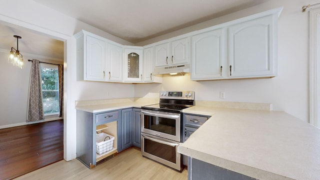 kitchen featuring kitchen peninsula, electric range, light hardwood / wood-style flooring, white cabinets, and hanging light fixtures