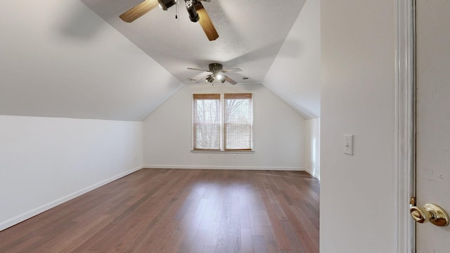 additional living space featuring ceiling fan, dark wood-type flooring, and lofted ceiling