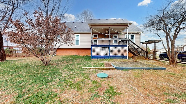 rear view of house with a yard