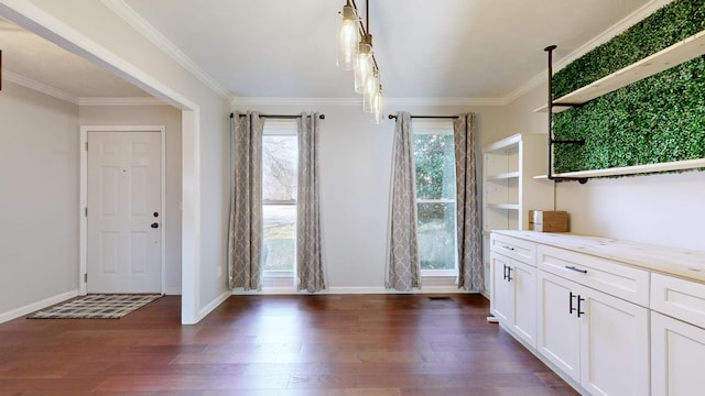 interior space featuring dark wood-type flooring and ornamental molding