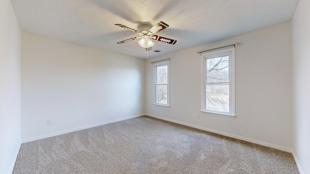 empty room featuring carpet floors and ceiling fan