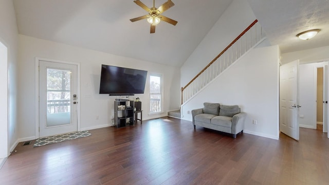 living room with dark hardwood / wood-style flooring, ceiling fan, and plenty of natural light