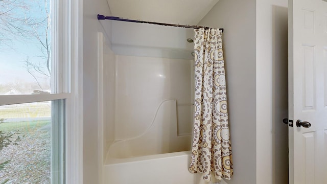 bathroom with shower / bathtub combination with curtain