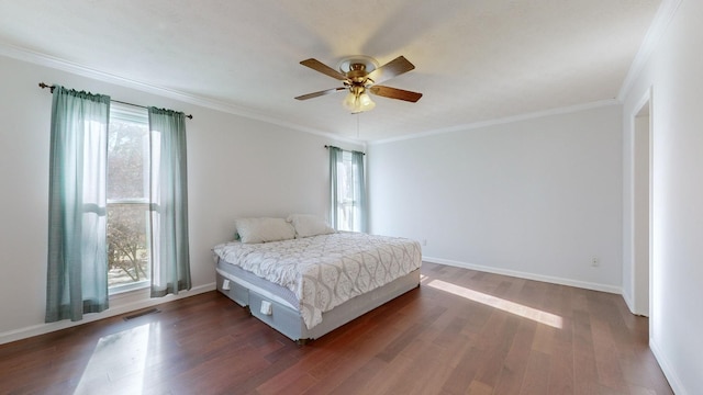 bedroom with dark hardwood / wood-style floors, ceiling fan, and ornamental molding