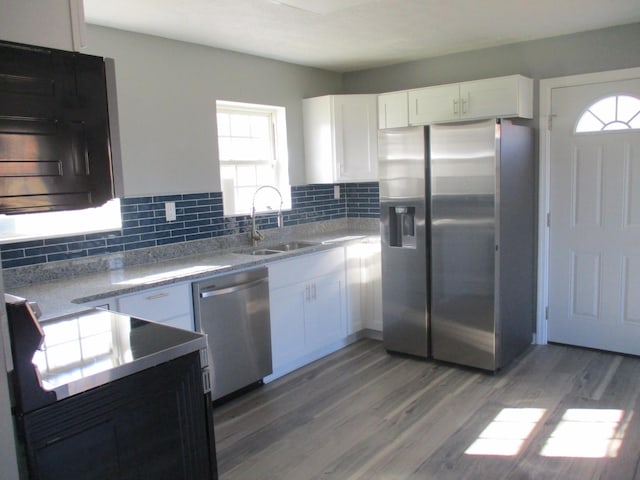 kitchen with hardwood / wood-style flooring, sink, white cabinets, and appliances with stainless steel finishes