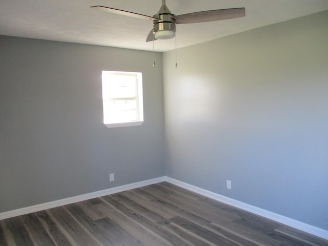 empty room with ceiling fan and dark hardwood / wood-style flooring