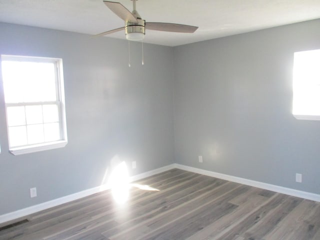 unfurnished room featuring ceiling fan and dark wood-type flooring