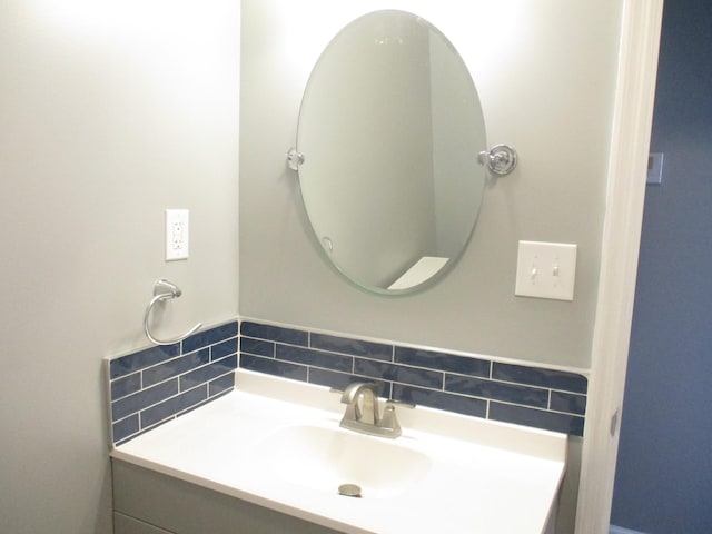 bathroom featuring decorative backsplash and vanity