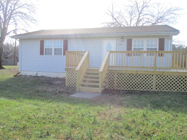 view of front of house featuring a deck and a front lawn