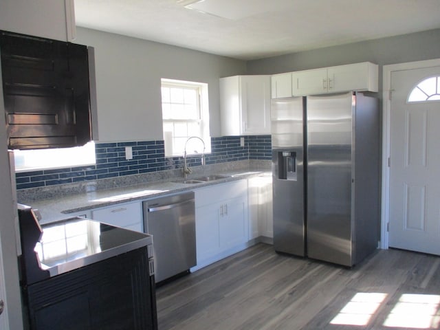 kitchen with white cabinetry, sink, stainless steel appliances, and dark hardwood / wood-style floors