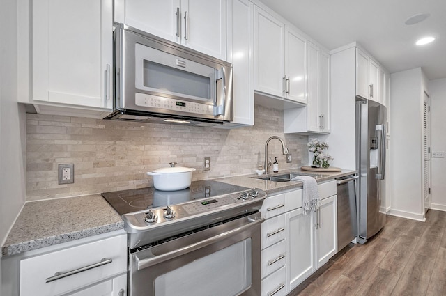 kitchen featuring sink, white cabinets, and appliances with stainless steel finishes