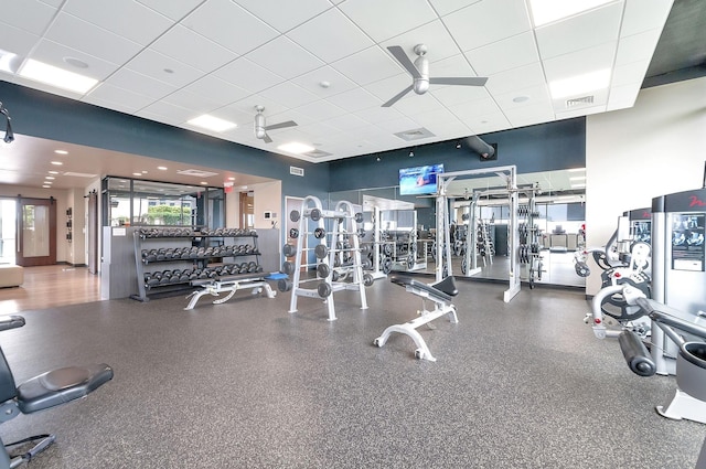 exercise room featuring a drop ceiling and ceiling fan