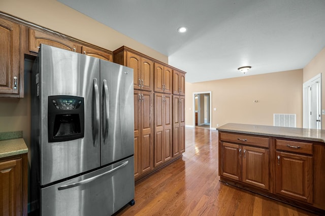 kitchen with dark hardwood / wood-style floors and stainless steel refrigerator with ice dispenser