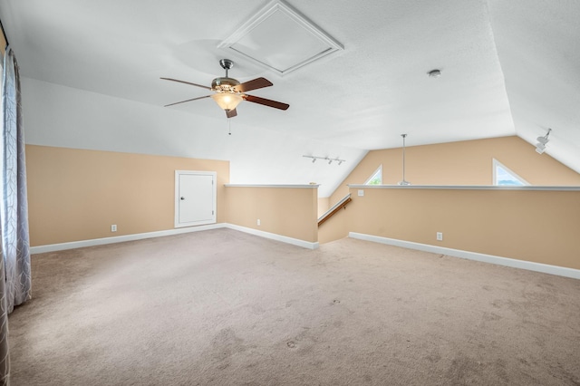 interior space featuring carpet flooring, ceiling fan, and lofted ceiling