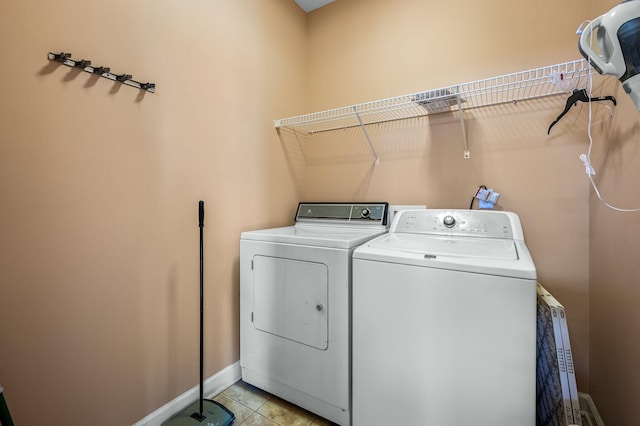 clothes washing area featuring light tile patterned flooring and independent washer and dryer