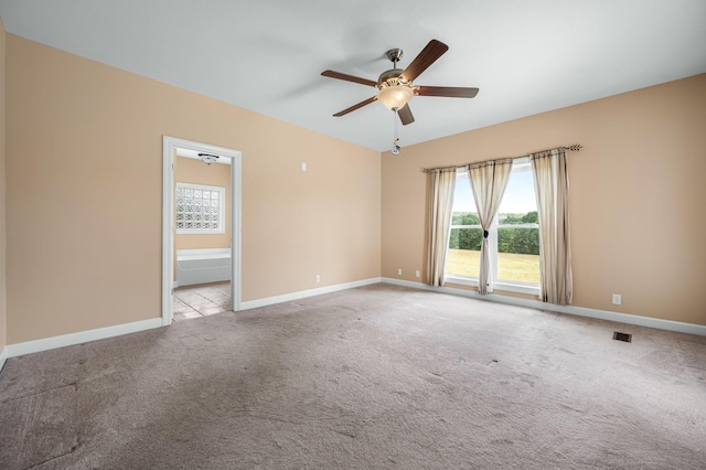 empty room featuring ceiling fan and light colored carpet