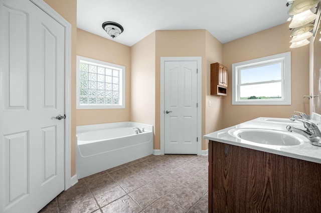 bathroom featuring vanity and a tub to relax in