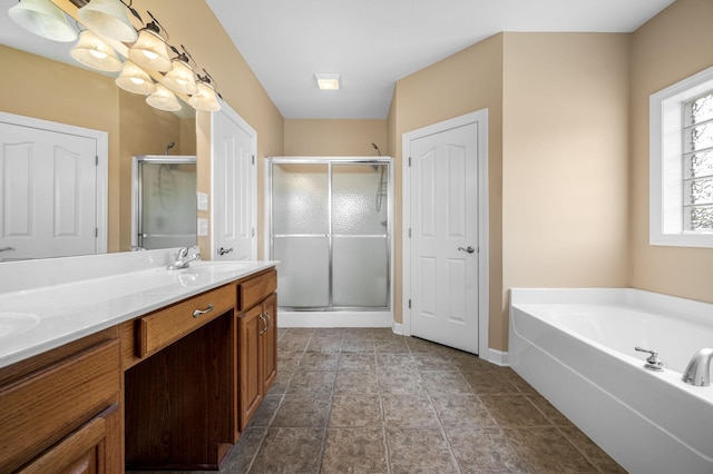 bathroom with vanity and shower with separate bathtub